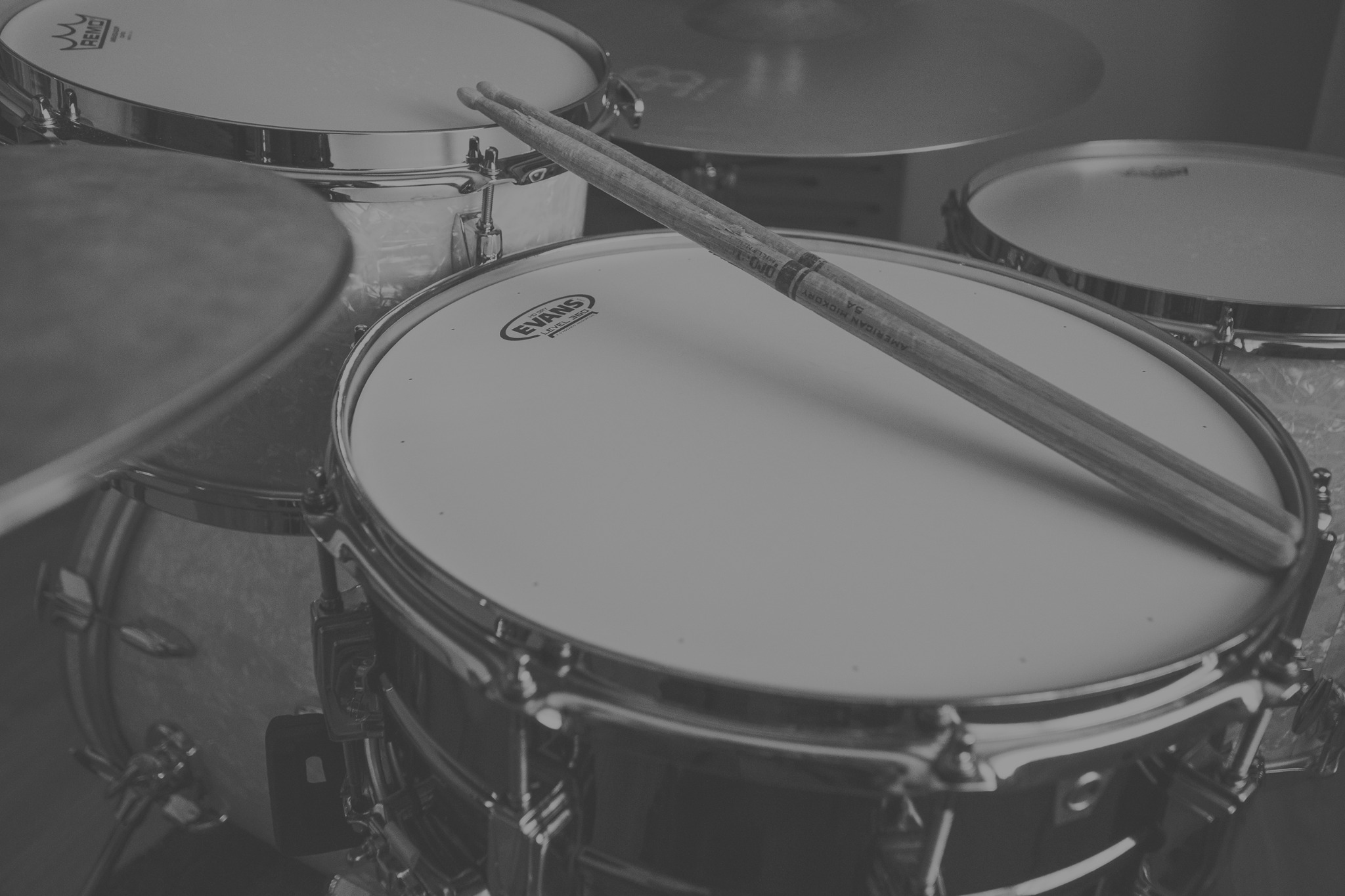 Acoustic drum kit in a warmly lit recording studio